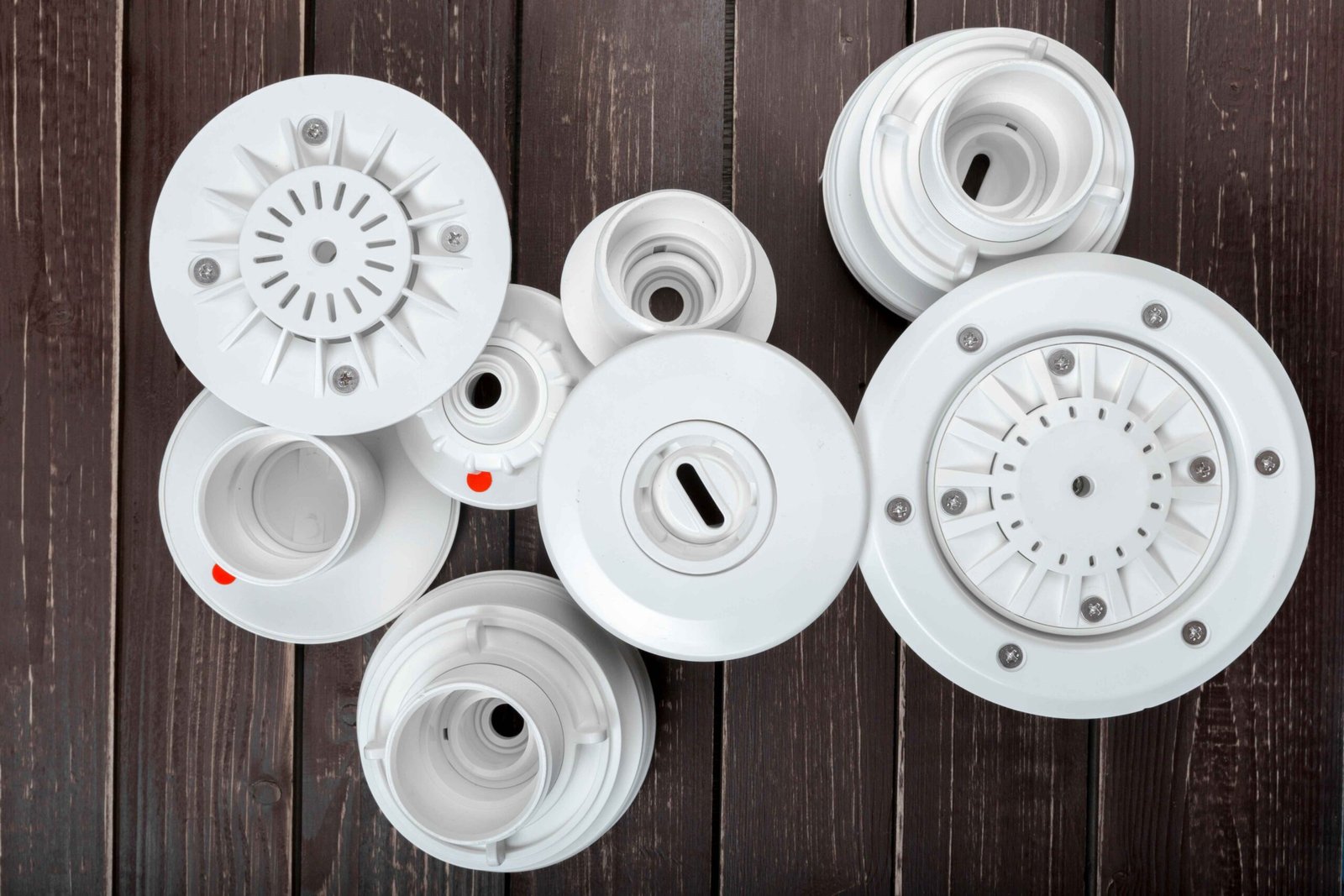Technicians inspecting precision-molded components for washing machine assembly lines.