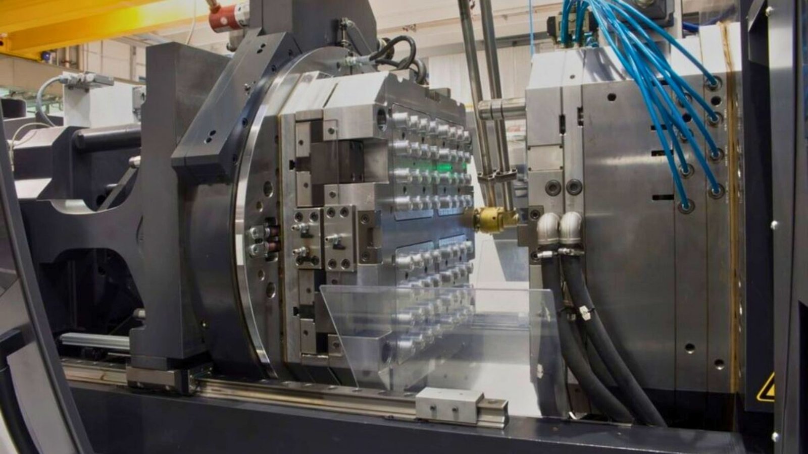 24/7 automated injection molding line producing high-precision plastic parts at scale