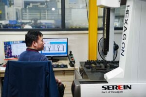 Engineer inspecting component using CNC technology during prototyping at Haumann Technology