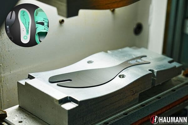 Modern sports gear factory with robotics and advanced manufacturing equipment.