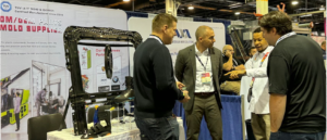 Haumann project manager in discussion with U.S. OEM engineering team at PTXPO booth