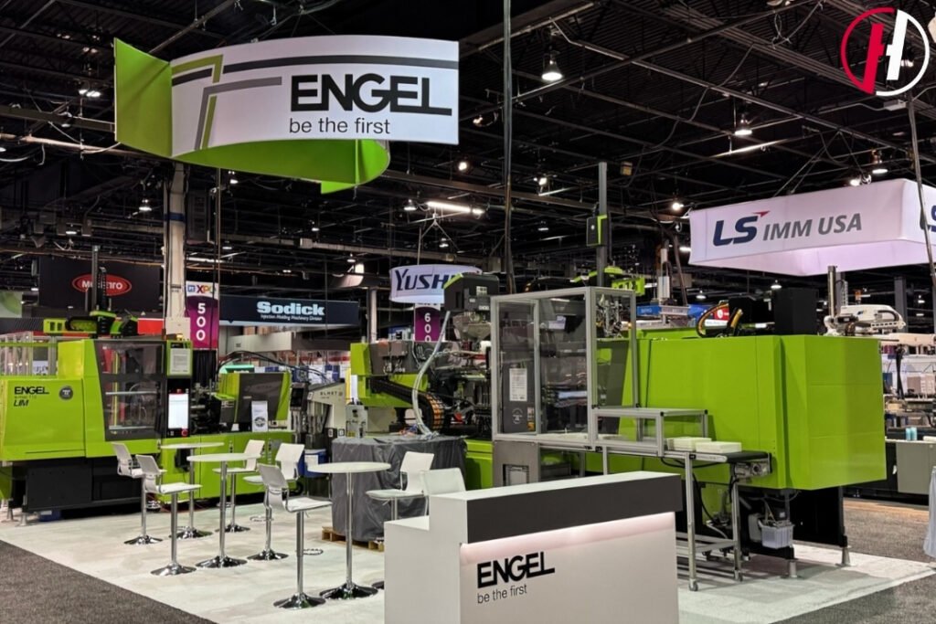 Martin Aicher, Founder of Haumann Group, speaking with OEM engineers at PTXPO Chicago 2026