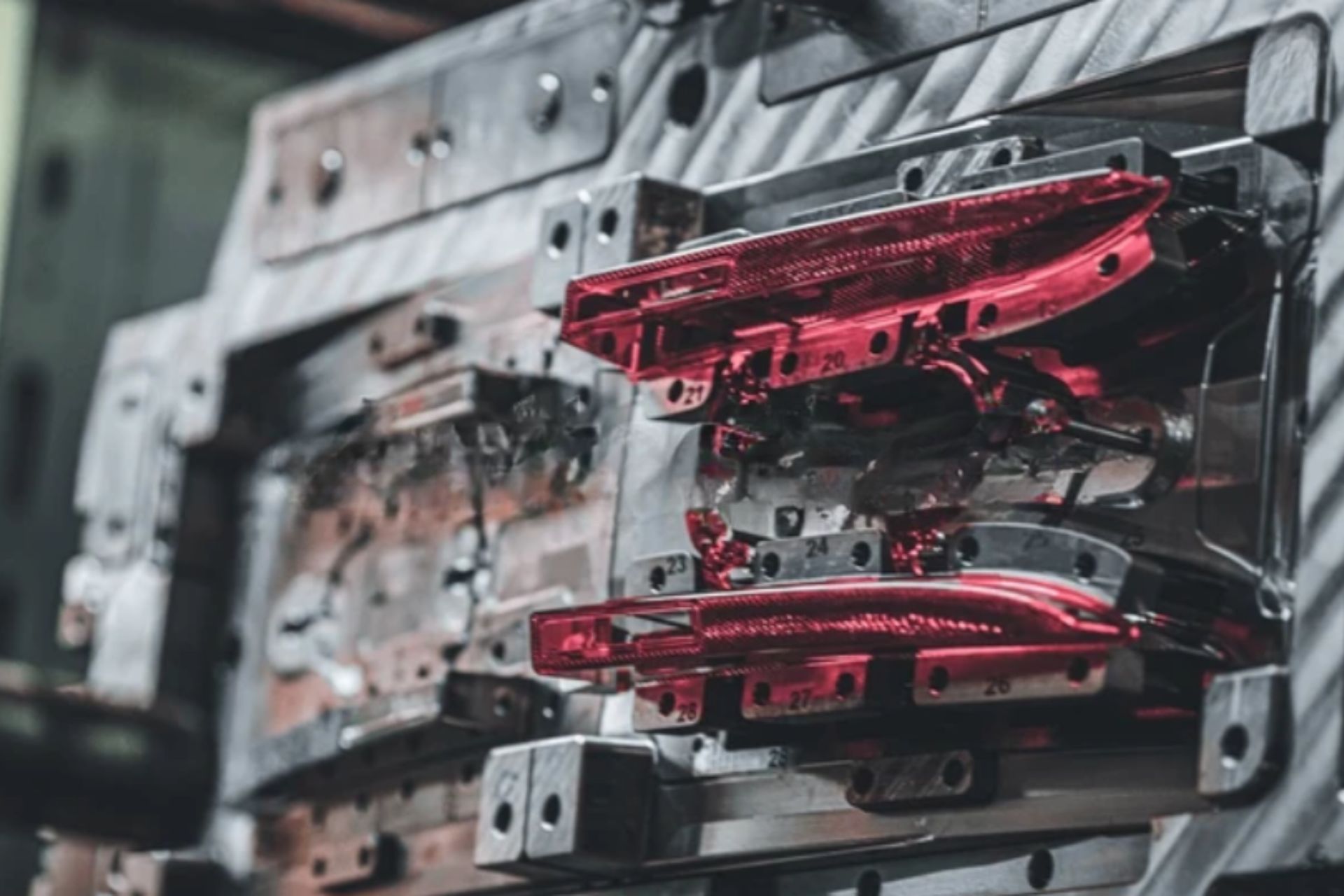 Custom plastic injection molding machine in action with molten plastic being injected into a mold.