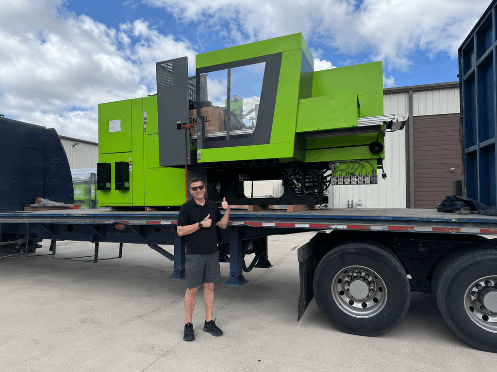HAUMANN Group team member with the new ENGEL injection molding machine at the Houston manufacturing facility.