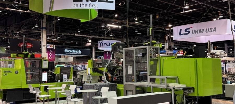 Martin Aicher, Founder of Haumann Group, speaking with OEM engineers at PTXPO Chicago 2026